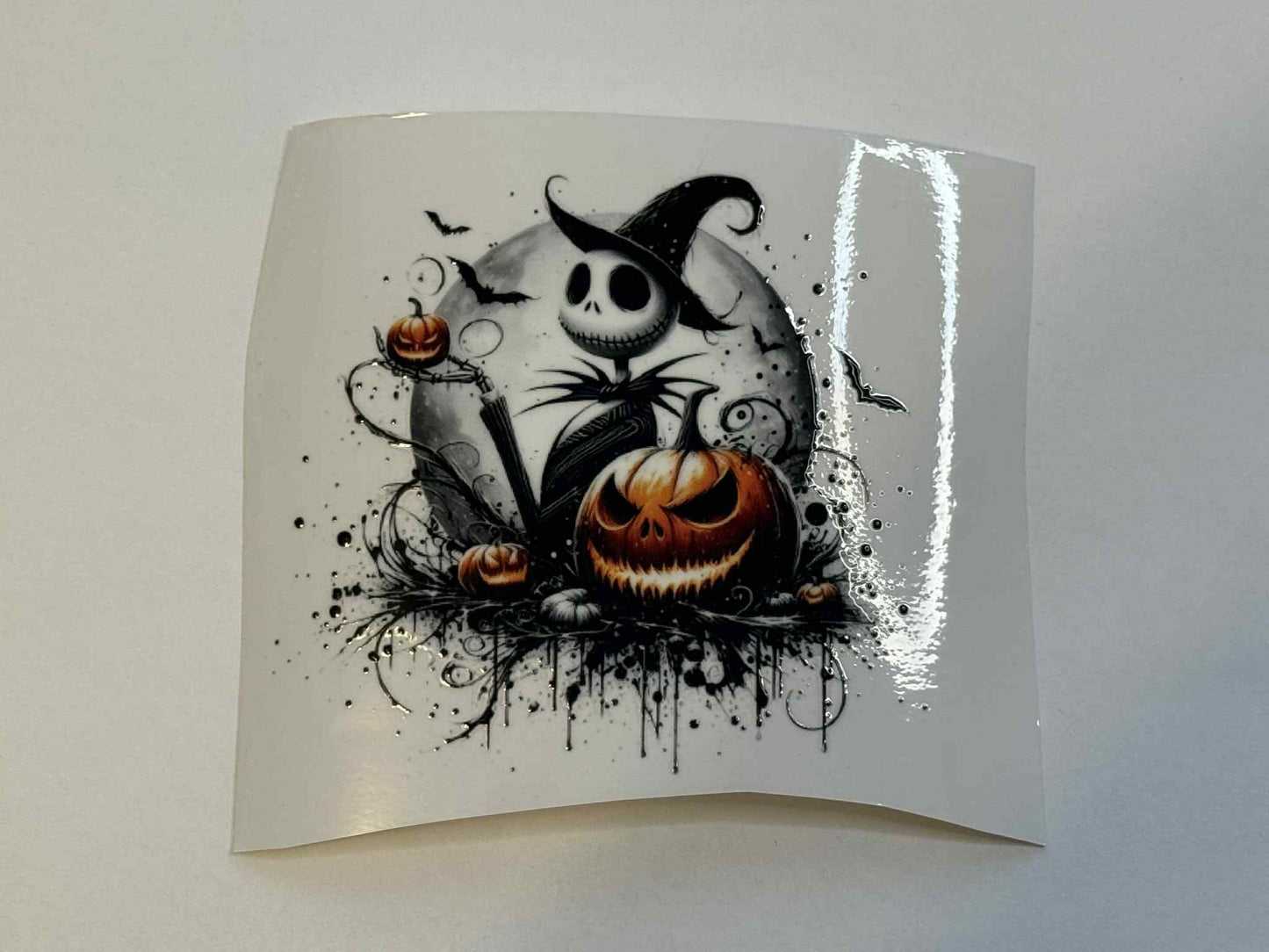 Halloween-themed design with pumpkins and skull on a white card